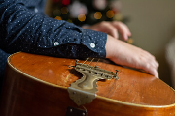 closeup on young boy hands playing acoustic guitar strings