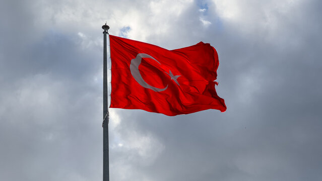  Turkish flag waving in blue cloudly sky. 19 mayis, 23 nisan, 15 temmuz, 30 agustos, 29 ekim, 10 kasim. Turkish nation. 19 may, 23 april, 15 july, 30 august, 29 october.