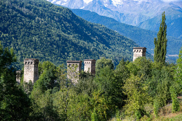 Fototapeta na wymiar Villages and settlements at the foot of the Ushba mountain. Wild rivers and wooden bridges that break off from the Chaladi Glacier. Famous Svan towers in the village.