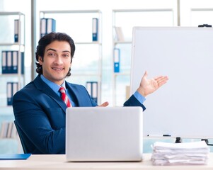 Young handsome businessman in front of whiteboard