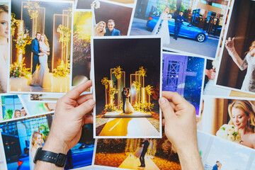 men's hands lay out Beautiful printed wedding photos. Professional photography.