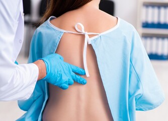 Injured young woman visiting young male doctor