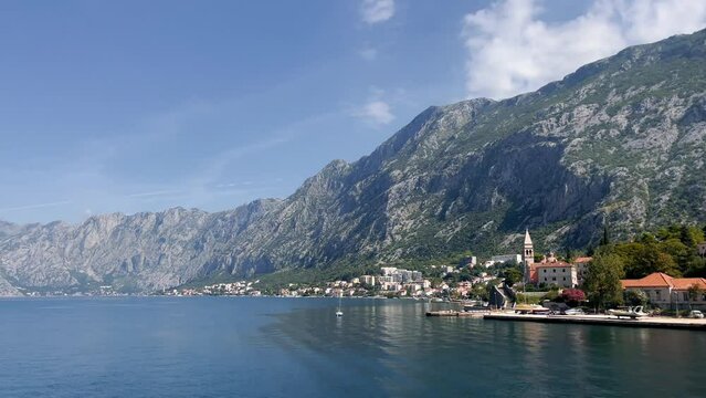 Tower St. Matthias Church in Dobrota town, Montenegro. Photo shot from a passing ship 4K.
