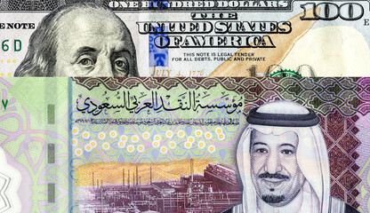 Saudi Arabia banknote with King Salman and American dollars banknote with Benjamin Franklin. Business concept of the exchange rate, stock exchange