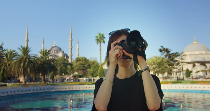 Travel blogger taking photo on camera in Istanbul, female taking pictures in summer vacation trip