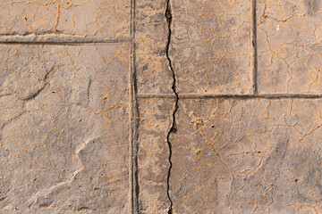 Old cracked stamped concrete floor texture background. Rough and grunge surface background.	
