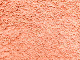 Abstract orange rough wall textured background with copy space. Rough painted cement wall texture.