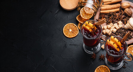 Mulled wine is the main drink of Christmas markets on a dark background. Christmas banner.