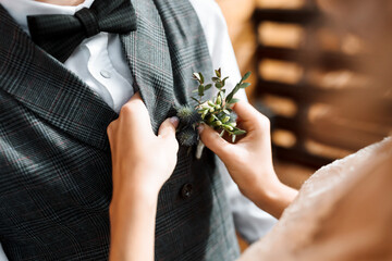 the bride clings to the groom's flower. First meeting. Wedding in a rustic style. Bride's hands...