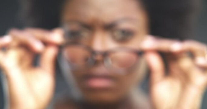 Optometry, vision and woman with glasses for sight with blurry view in studio and dark background. Happy, African and portrait of model with eyewear, spectacles and lenses in frame with a smile