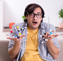 Young student physicist preparing for exam at home