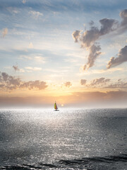 Naklejka na ściany i meble Beautiful catamaran on the sea at sunset - copy space 