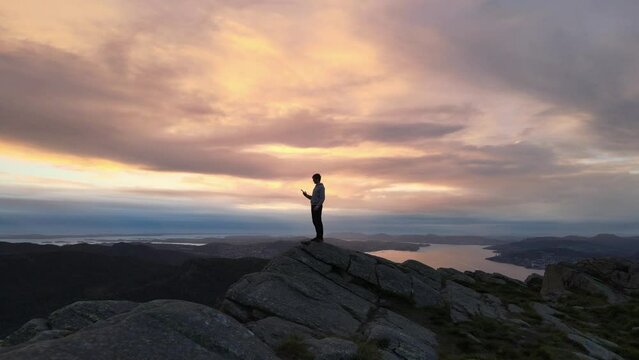 silhouette contrasting orange glowing sky in Bergen Noway, flying forward