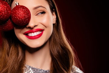 Close up photo of joyful pretty girl hold close face with christmas tree baubles prepare event...