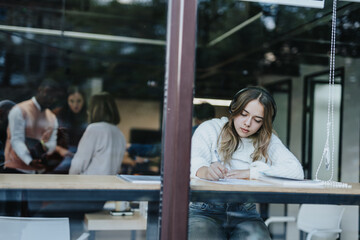 A group of professionals in an office, working together on business strategies, analyzing financial data, and planning for market expansion.