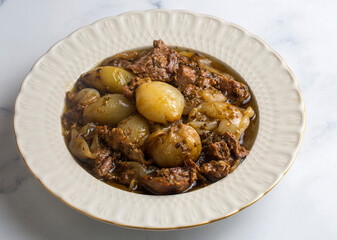 From Turkish cuisine; Onion stew with entrecote. Turkish name; Antrikotlu yogan guvec or yahni