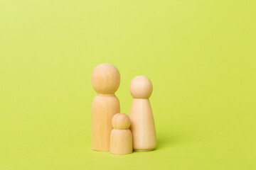 Wooden family figures on color background