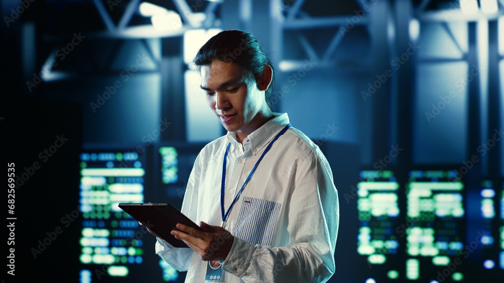 Poster proactive employee walking through data center electronics providing processing resources for differ