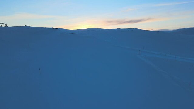 Sunset revealed over snowy hills in Voss, Norway