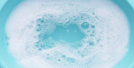 Detergent foam bubble on water. Blue background, Soap sud