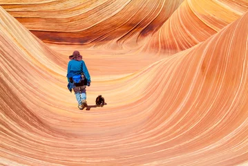 Rolgordijnen Girl and Dog hiking on The Wave in Arizona Natural Sandstone Formation © David G. Rigg