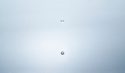 Blue water circles surface with rings and ripples from drop splash