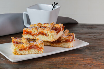 Argentine quince cake accompanied by a cup of coffee on the table.