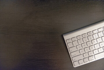 Modern Computer Keyboard on Dark Wooden Desk