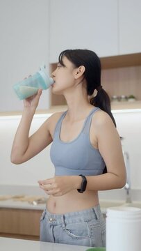 Asian woman drinking whey protein in the morning.