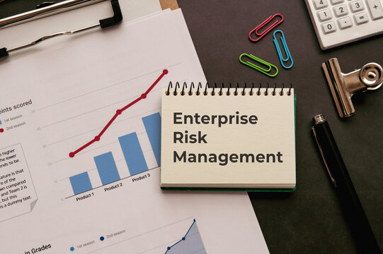 There is notebook with the word Enterprise Risk Management. It is as an eye-catching image.