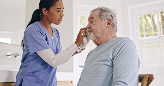 Sick, cleaning or caregiver helping an old man in nursing home, retirement clinic for wellness or support. Face towel, health or elderly patient with nurse or social worker for senior care service