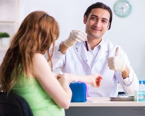 Young pregnant woman in blood transfusion concept