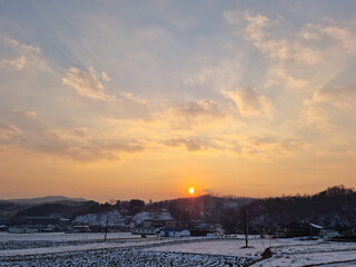 Rural winter landscape at sunset
