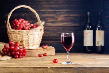 red grape juice in a glass placed on a wooden table or red wine, a delicious natural fruit juice drink