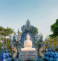 Obraz premium Budhist shrine with statues,outside Wat Rong Suea Ten,Blue Temple,Chiang Rai city,Northern Thailand.