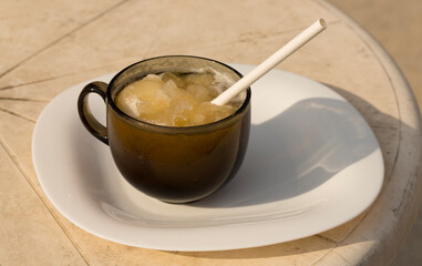 Ice beer. Creative drink. A glass mug with beer and a straw.