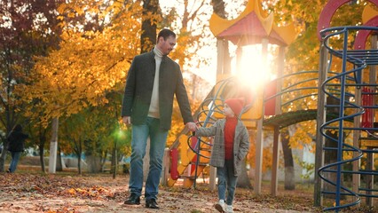Cute daughter and bearded dad decide to explore hidden paths of autumn park
