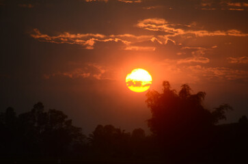 Scenic view dramatic beautiful sunset sky. Natural Sunset Sunrise on meadow silhouette shadow dark land. Vibrant dramatic sky on sunset, dawn, sunrise in Countryside. Landscape Colorful Sky At Sunset