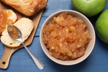 Flat lay composition with delicious apple jam on blue wooden table