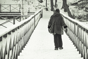 a person walking on a snow covered bridge