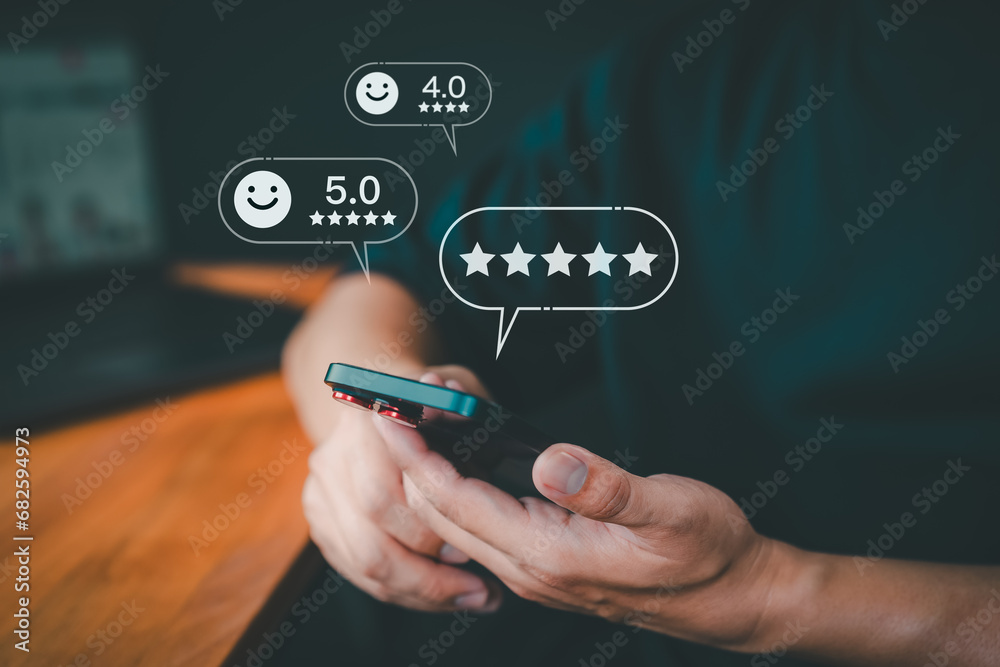 Poster customer use a smartphone give point 5 stars and smile face icon for feedback review satisfaction se