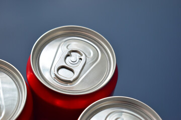close up top of aluminium red cans soft drink put on blue texture background