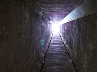 Fototapeta na wymiar exit light in the dark tunnel