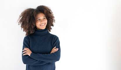 Portrait of beautiful positive african american woman standing with arms crossed on white background.