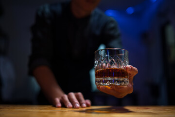 Barman pouring whiskey whiskey glass..