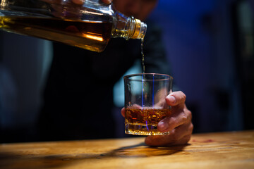 Barman pouring whiskey whiskey glass..