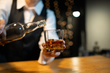 Barwoman pouring whiskey whiskey glass beautiful night