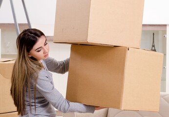 Young beautiful woman moving to new flat