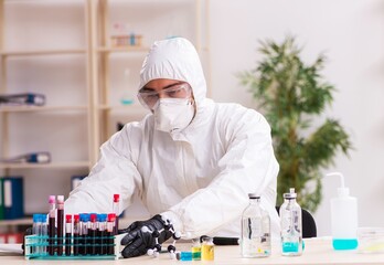 Doctor working in lab in coronavirus COVID-19 concept