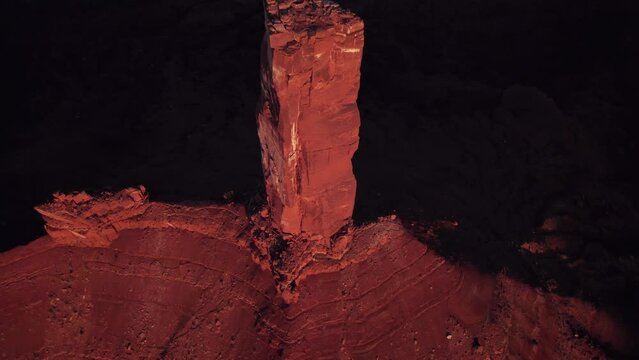 Aerial flyover tilts to small peak of Moab rock spire, Castleton Tower